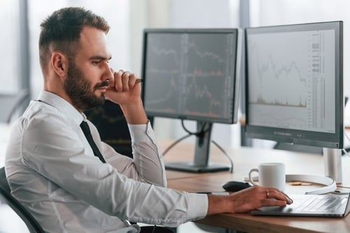 Employee looking at data on computer screens